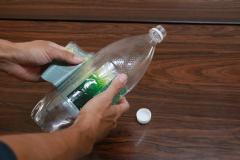 Photo: Removing the cap and label from a plastic bottle