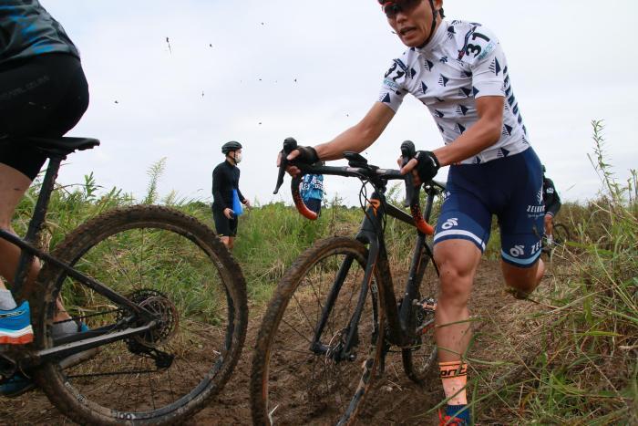 Photo: A player running while kicking up mud