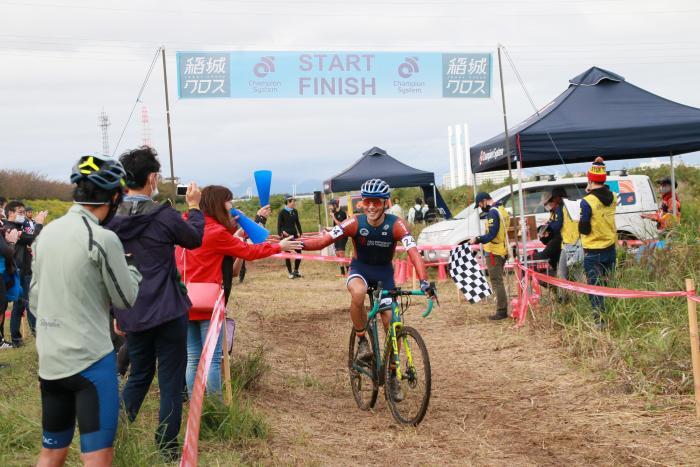 Photo: A player smiling as they cross the finish line